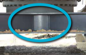 An excavator’s reinforced idler frames circled in blue.