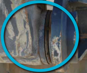 The joint between the arm and the bucket on an excavator circled in blue.