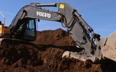 Pack up of a Volvo excavator increase and arm digging grime.