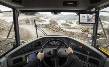 A view of a quarry from a Volvo articulated hauler operator’s perspective. The Haul Assist in-cab display can be seen on the right side of the cab.